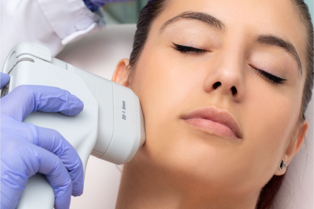 Top view of woman having facial hifu energy treatment